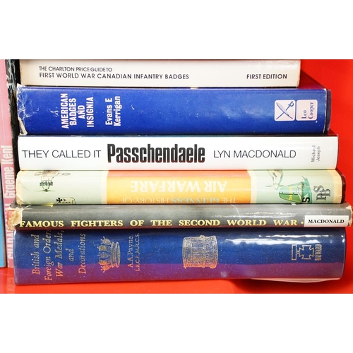 236 - A large collection of military reference books to include Badge, Button, Medal and sword examples.