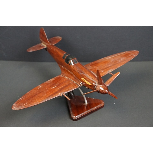 286 - A carved wooden model of a RAF Spitfire on wooden plinth