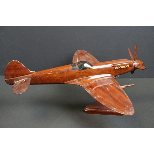 286 - A carved wooden model of a RAF Spitfire on wooden plinth