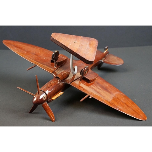 286 - A carved wooden model of a RAF Spitfire on wooden plinth