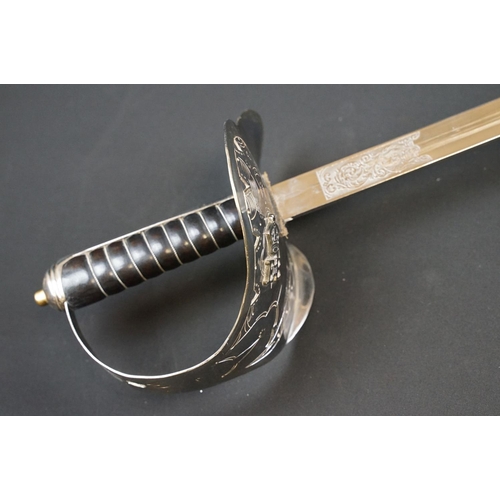 140 - A British military officers dress sword, etched blade with the QEII cypher, complete with scabbard.