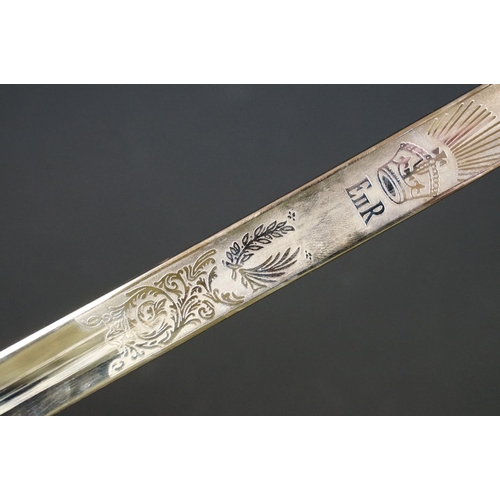 140 - A British military officers dress sword, etched blade with the QEII cypher, complete with scabbard.