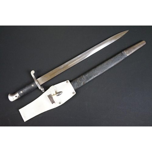 197 - A British bayonet with good clear markings to the blade complete with scabbard and white leather fro... 