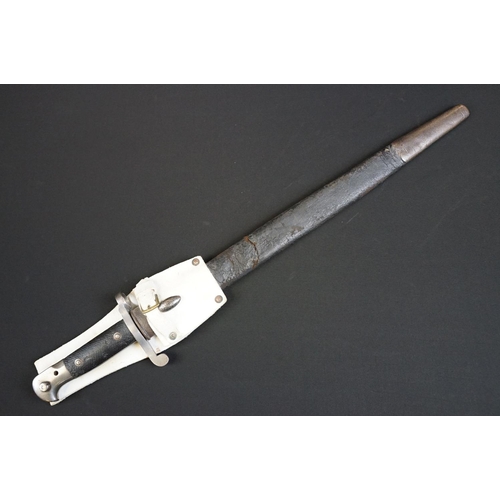 197 - A British bayonet with good clear markings to the blade complete with scabbard and white leather fro... 