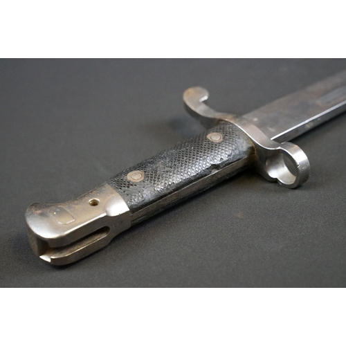 197 - A British bayonet with good clear markings to the blade complete with scabbard and white leather fro... 