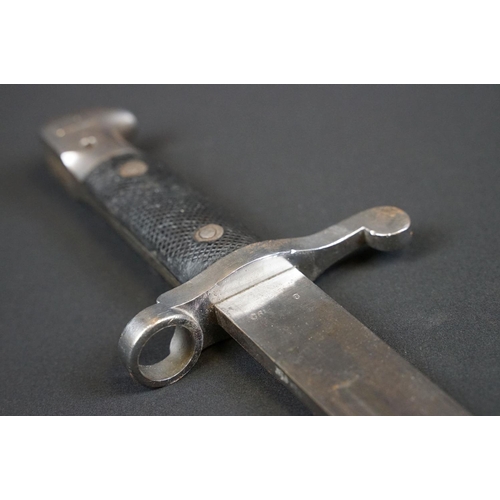 197 - A British bayonet with good clear markings to the blade complete with scabbard and white leather fro... 