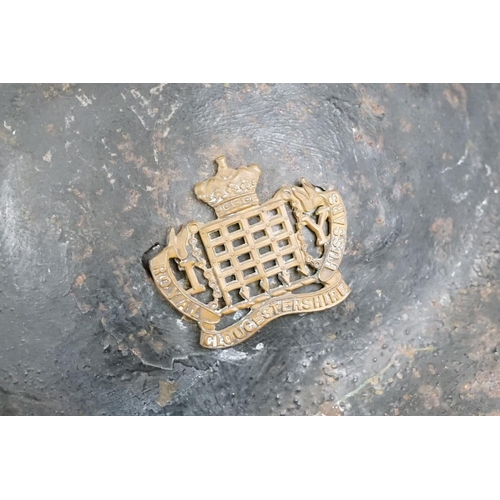 199 - A British World War One Brodie helmet badged to the Royal Gloucestershire Fusiliers.