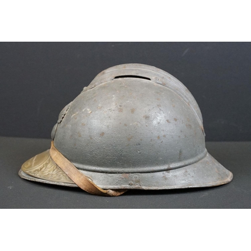 201 - A World War One French Adrian Helmet complete with liner and veterans peak plaque.