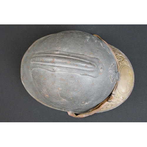 201 - A World War One French Adrian Helmet complete with liner and veterans peak plaque.