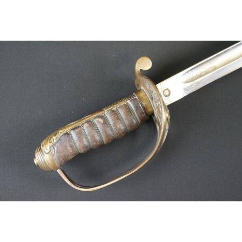 214 - A British Victorian Infantry officers sword, VRI cypher to the brass guard, complete with scabbard.