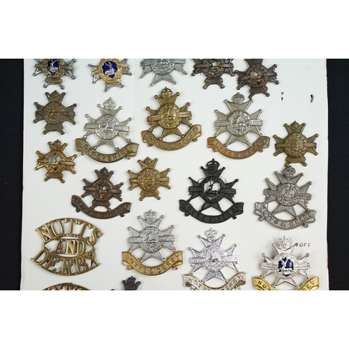 84 - A collection of Notts and Derby Regiment cap and collar badges to include KC, QC and QVC examples, i... 