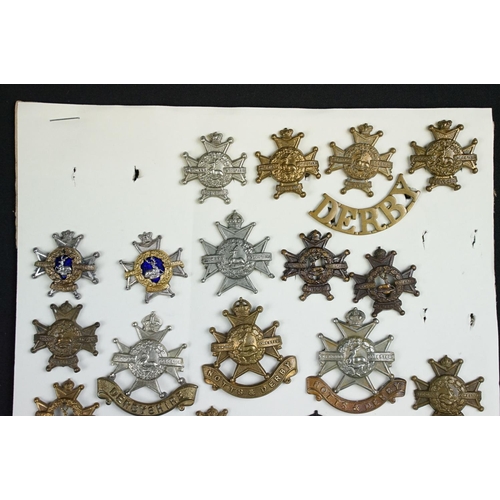 84 - A collection of Notts and Derby Regiment cap and collar badges to include KC, QC and QVC examples, i... 