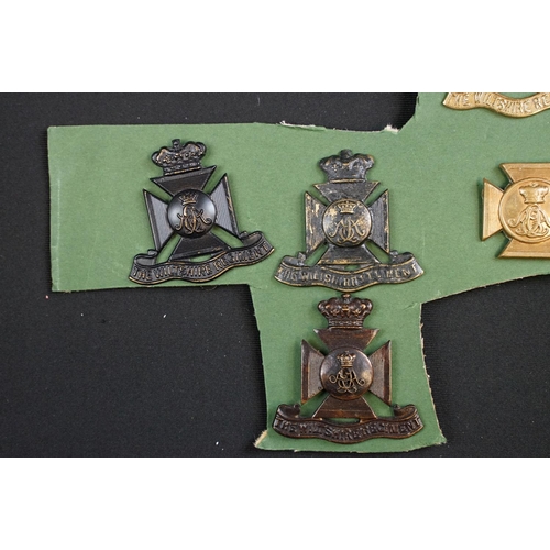 85 - A collection of The Wiltshire Regiment cap and collar badges.