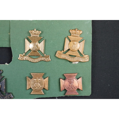 85 - A collection of The Wiltshire Regiment cap and collar badges.