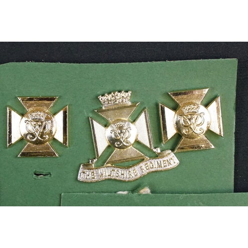 85 - A collection of The Wiltshire Regiment cap and collar badges.