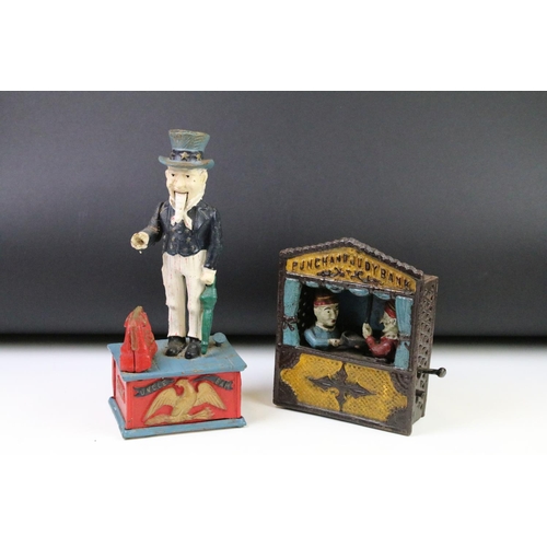 141 - Two reproduction cast iron money boxes to include a Punch and Judy box and an Uncle Sam example. Lar... 