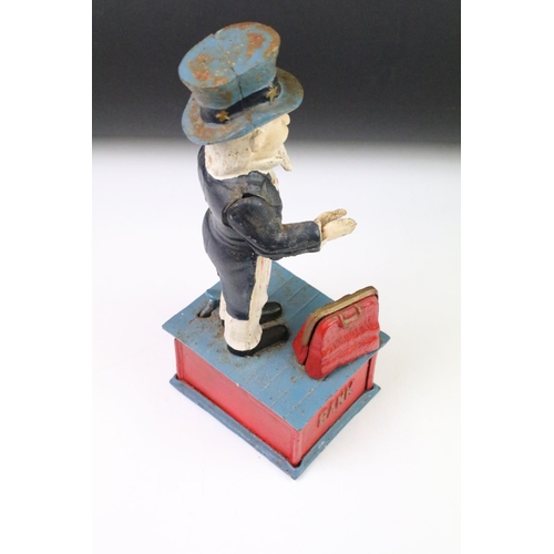 141 - Two reproduction cast iron money boxes to include a Punch and Judy box and an Uncle Sam example. Lar... 