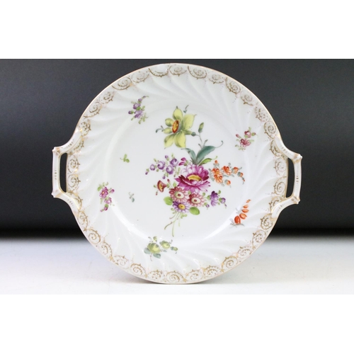 21 - Two Dresden porcelain twin handled plates with hand painted floral decoration and gilt detail to bor... 