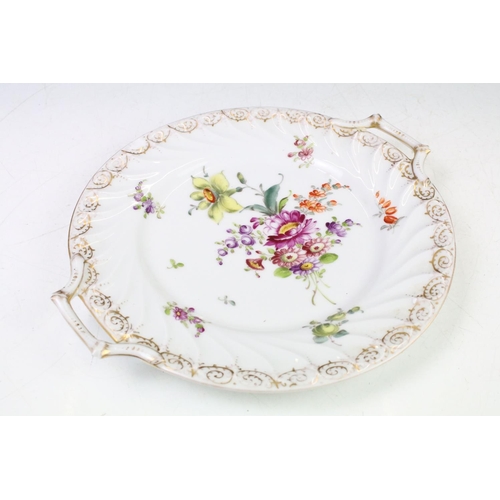 21 - Two Dresden porcelain twin handled plates with hand painted floral decoration and gilt detail to bor... 