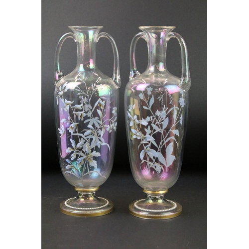 24 - Late 19th / early 20th century iridescent glass three-piece garniture set, with hand painted decorat... 