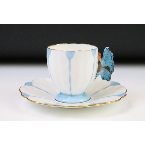 54 - Aynsley Art Deco tea cup and saucer having a butterfly formed handle, gilt rims and blue hand painte... 