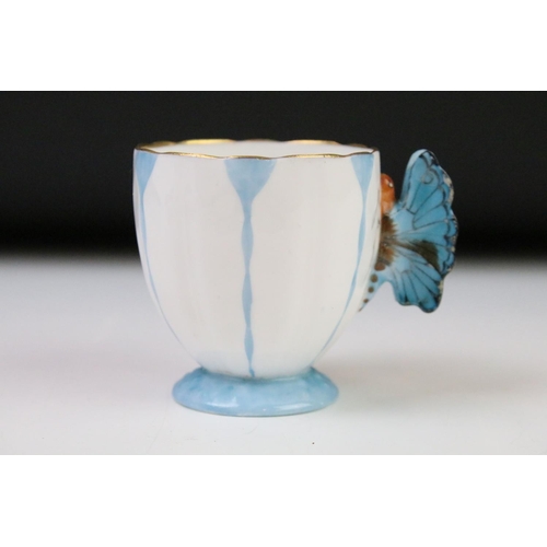 54 - Aynsley Art Deco tea cup and saucer having a butterfly formed handle, gilt rims and blue hand painte... 