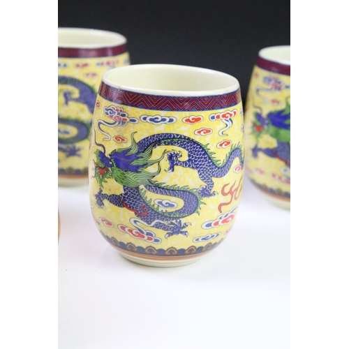 64 - 20th Century Chinese tea set including six tea cups and teapot, all being decorated with blue dragon... 