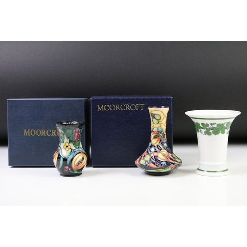 8 - Two boxed Moorcroft pottery vases to include a Celtic Web vase (10.5cm high) and a 'Fruits' example ... 