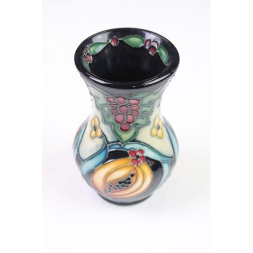 8 - Two boxed Moorcroft pottery vases to include a Celtic Web vase (10.5cm high) and a 'Fruits' example ... 