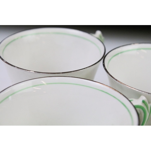 84 - Art Deco Roslyn china coffee set of angular form having a white ground with green star detailing, si... 