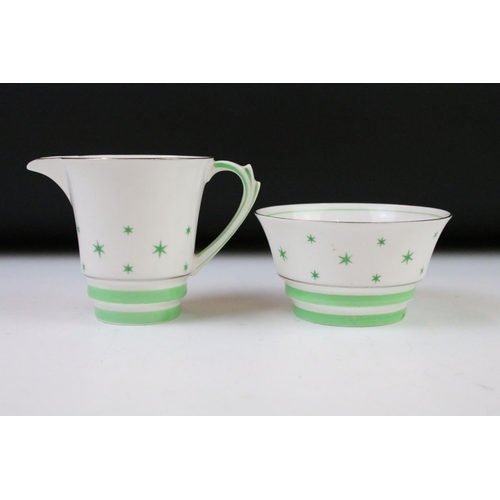 84 - Art Deco Roslyn china coffee set of angular form having a white ground with green star detailing, si... 