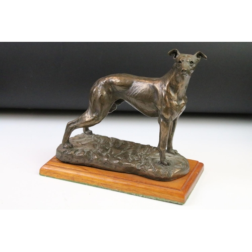 87 - Group of dog figurines to include a Minerva fine Arts resin greyhound, a heredities resin hound, a H... 