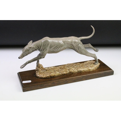 87 - Group of dog figurines to include a Minerva fine Arts resin greyhound, a heredities resin hound, a H... 