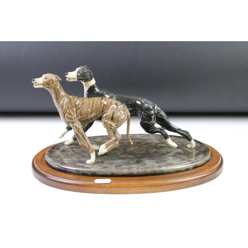 87 - Group of dog figurines to include a Minerva fine Arts resin greyhound, a heredities resin hound, a H... 