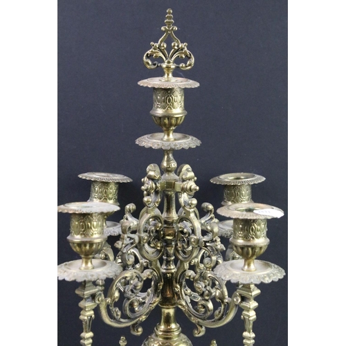 143 - Cast brass clock garniture set clock of scrolling form, the clock with pierced design, cream dial an... 