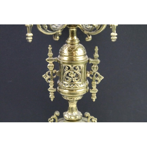 143 - Cast brass clock garniture set clock of scrolling form, the clock with pierced design, cream dial an... 