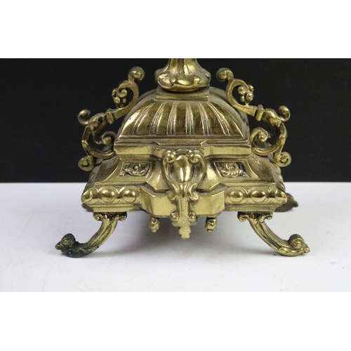 143 - Cast brass clock garniture set clock of scrolling form, the clock with pierced design, cream dial an... 