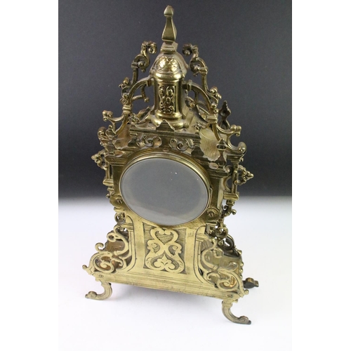 143 - Cast brass clock garniture set clock of scrolling form, the clock with pierced design, cream dial an... 