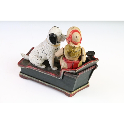 144 - Two reproduction cast iron novelty money boxes to include trick dog and speaking dog. Widest measure... 