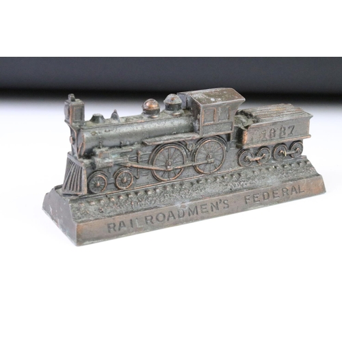 145 - Three cast metal money boxes to include Railroadmen's federal train money bank, cast brass county ba... 