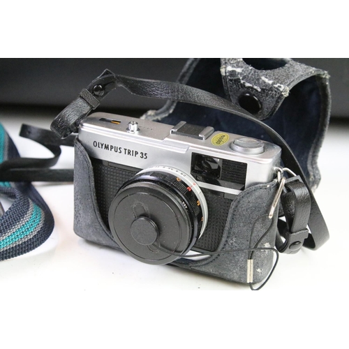 452 - Group of cameras to include an Olympus trip 35 film camera with tripod and camera bag, Praktica PL n... 