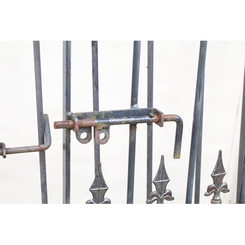 617 - Two wrought iron metal gates, with two gate posts, the larger 170cm high x 115cm wide (including hin... 