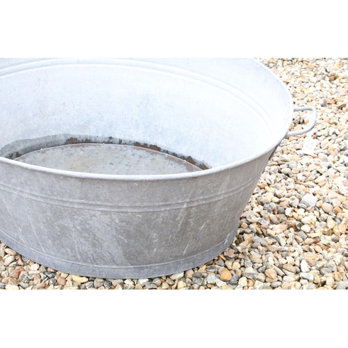 626 - Large galvanised oval garden planter or washtub with twin handles, 96cm long x 36cm high