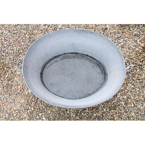 626 - Large galvanised oval garden planter or washtub with twin handles, 96cm long x 36cm high