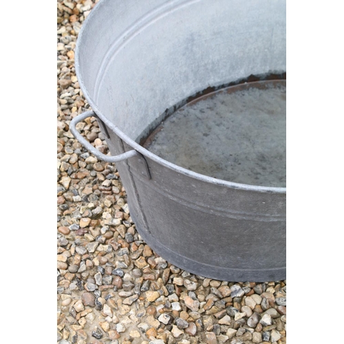 626 - Large galvanised oval garden planter or washtub with twin handles, 96cm long x 36cm high