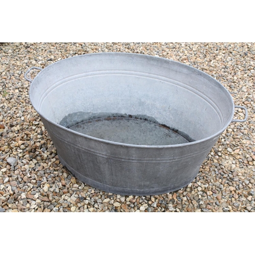 626 - Large galvanised oval garden planter or washtub with twin handles, 96cm long x 36cm high