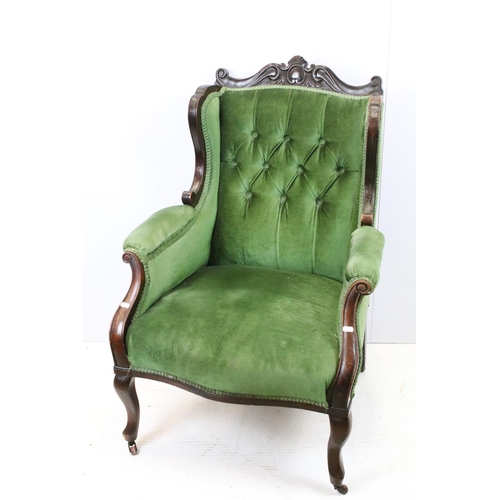 646 - Victorian mahogany armchair, with carved top rail, upholstered in green with button back, on cabriol... 