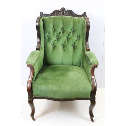 646 - Victorian mahogany armchair, with carved top rail, upholstered in green with button back, on cabriol... 