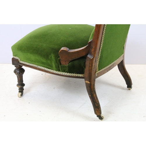 647 - Edwardian nursing chair, with carved back, upholstered in green with button back, on turned legs and... 