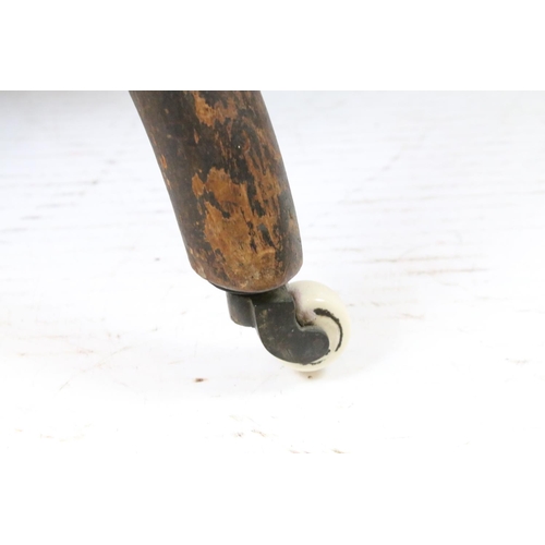 647 - Edwardian nursing chair, with carved back, upholstered in green with button back, on turned legs and... 